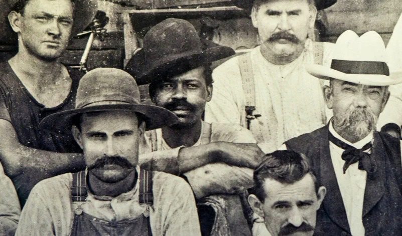 Historic photograph of Nathan “Nearest” Green with fellow distillery workers, illustrating the legacy behind the Uncle Nearest lawsuit.